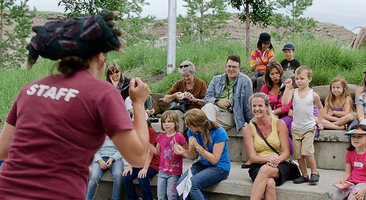 An educator gives a presentation to a group of people.